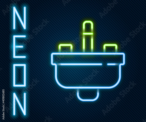 Glowing neon line Washbasin with water tap icon isolated on black background. Colorful outline concept. Vector.