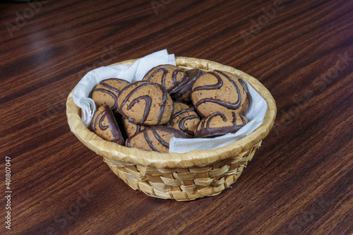Dark chocolate butter cookies in a straw basket.