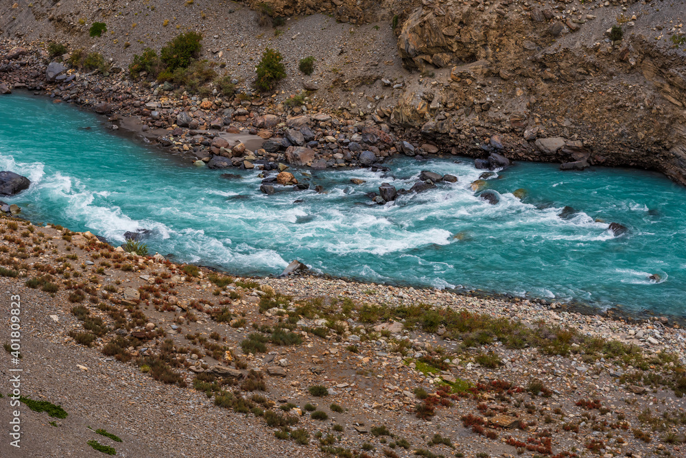 Turquoise color water of spiti river due to presence of high concentrations of dissolved lime from rocks of glaciated mountains in Himalayas of Himachal Pradesh, India