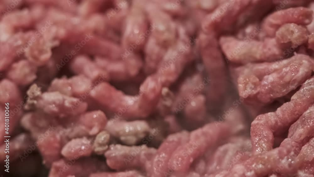 Stirring Delicious Red Minced Beef Meat with Wooden Spoon. Macro View Food Concept Stirring Delicious Red Minced Beef Meat with Wooden Spoon. Macro View Food Concept