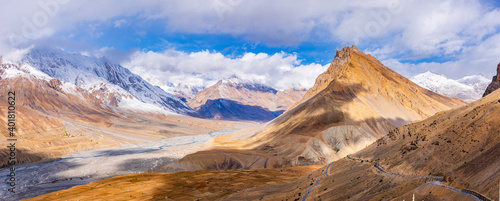 Serene Landscape of Spiti river valley & snow capped mountains during sunrise near Kaza town in Lahaul & Spiti district of Himachal Pradesh, India.