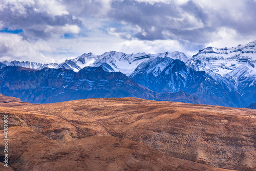 Panoramic Landscape of Spiti valley with snow capped mountains in background near Hikkim and Langza village of Kaza town in Lahaul and Spiti district of Himachal Pradesh, India.