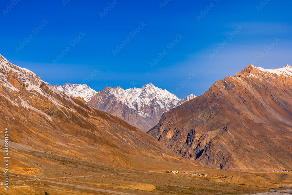 Serene Landscape of Spiti river valley and snow capped mountains during sunrise near Kaza town in Lahaul and Spiti district of Himachal Pradesh, India.