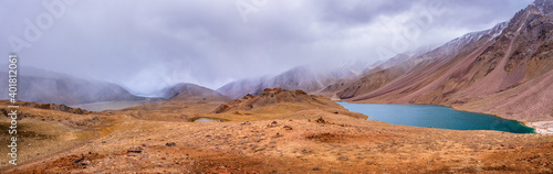 Panoramic view of Chandratal or Lake of the moon is a high altitude lake located in Himalayas of Spiti Valley, Himachal Pradesh, India. The name of Lake originated due to its crescent moon like shape.