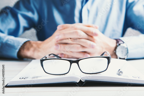 businessman tired of reading with glasses