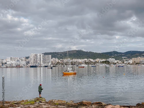 A beautiful seascape with parked boats and building in Sant Antoni de Portmany photo