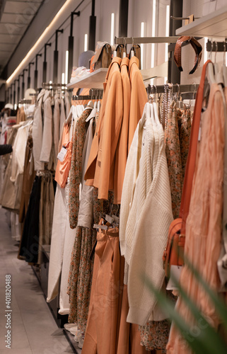 Women clothing collection on hangers in the store. the concept of conscious consumption and recycling of things © Maryna