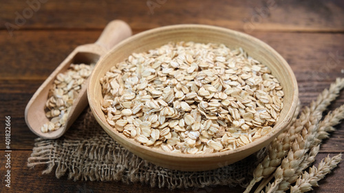 Rolled oats in a wooden bowl. Healthy whole grain oats