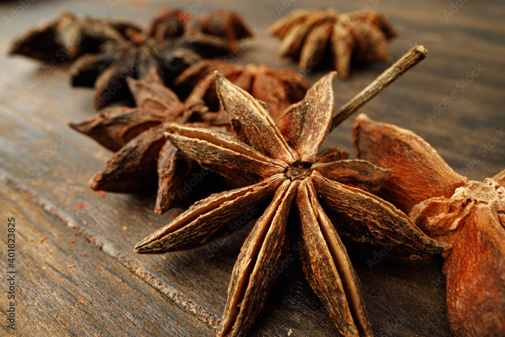 Macro photo of anise stars on wooden background Macro photo of anise stars on wooden background