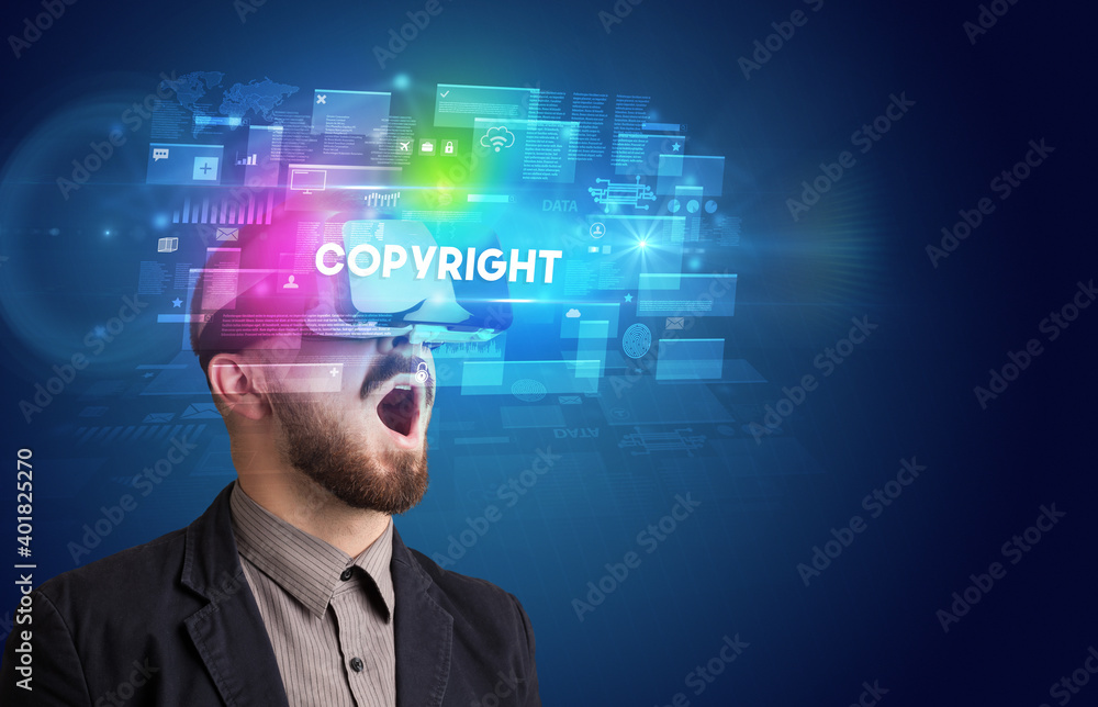 Businessman looking through Virtual Reality glasses with COPYRIGHT inscription, innovative security concept Businessman looking through Virtual Reality glasses with COPYRIGHT inscription, innovative security concept