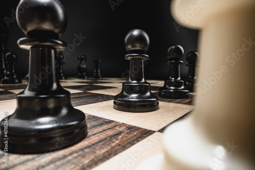 Chess board with figures on dark background