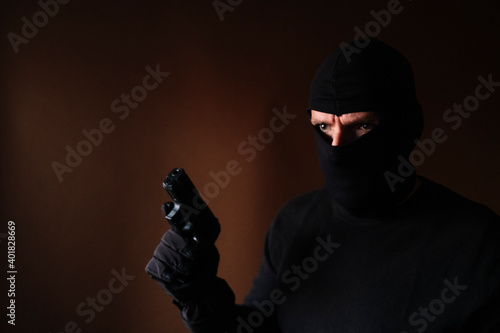 Series of a Caucasian burglar breaking into a house with gun in hand.