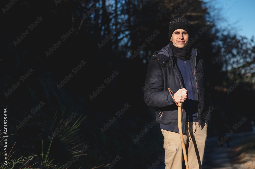 Guy walking in a natural landscape during winter season practicing outdoors activities looking at the camera. Guy walking in a natural landscape during winter season practicing outdoors activities looking at the camera.