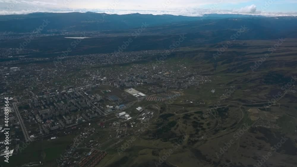 Scenic aerial view of cloudy city landscape and mountains from airplane window. Concept of aviation, flying transport and travel. Majectic high angle view of beautiful cloudscape. Scenic aerial view of cloudy city landscape and mountains from airplane window. Concept of aviation, flying transport and travel. Majectic high angle view of beautiful cloudscape.