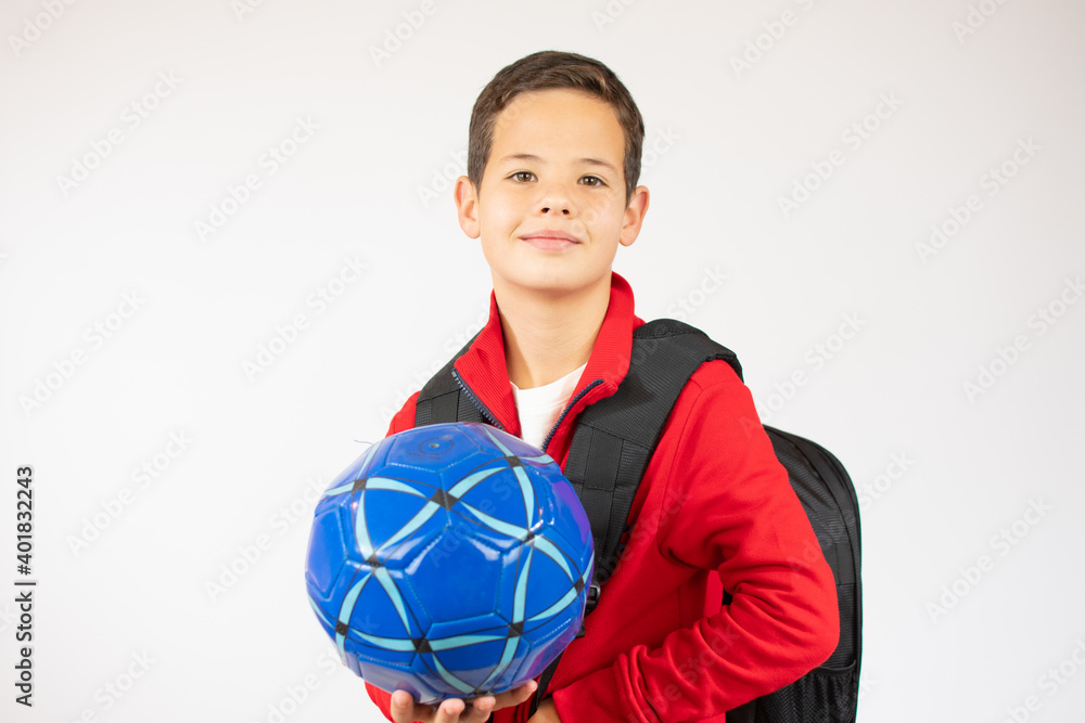 Happy young school boy holding a football. Isolated on white background Happy young school boy holding a football. Isolated on white background