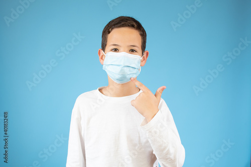 young ten years old boy in medical mask, concept of quarantine and protection from polluted air © Danko