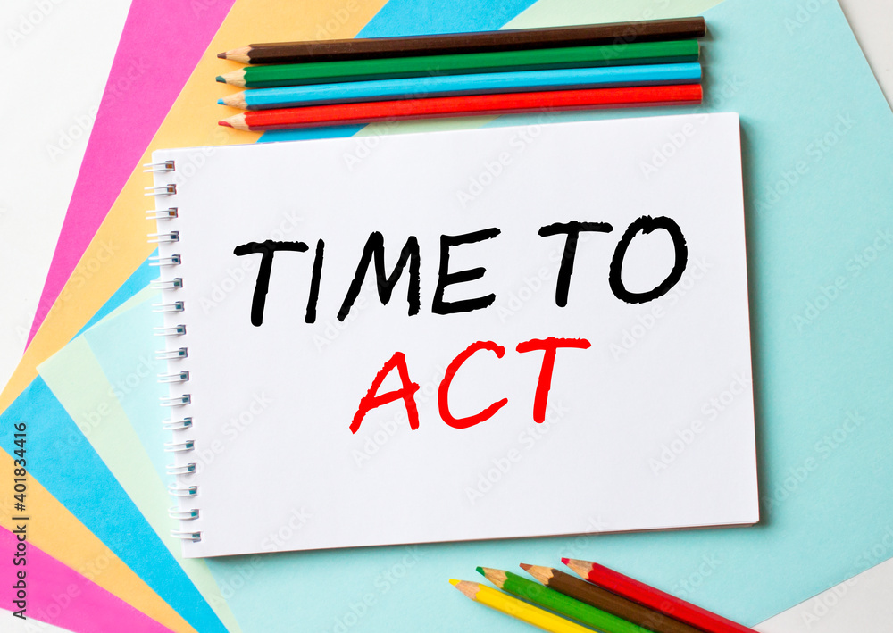 The Notepad with the text Time To Act is on colored paper with color pencils The Notepad with the text Time To Act is on colored paper with color pencils