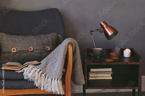 Hygge style interior, cozy home with cup of tea and candles