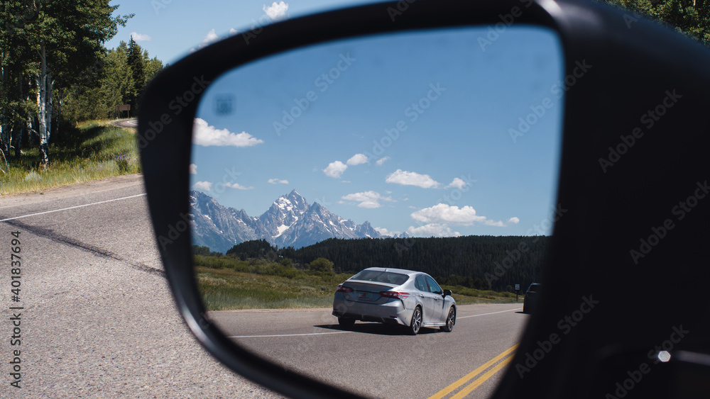 large mountains through a car side mirror