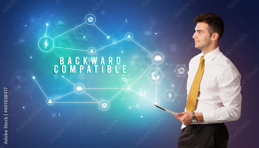 Businessman in front of cloud service icons with BACKWARD COMPATIBLE inscription, modern technology concept Businessman in front of cloud service icons with BACKWARD COMPATIBLE inscription, modern technology concept