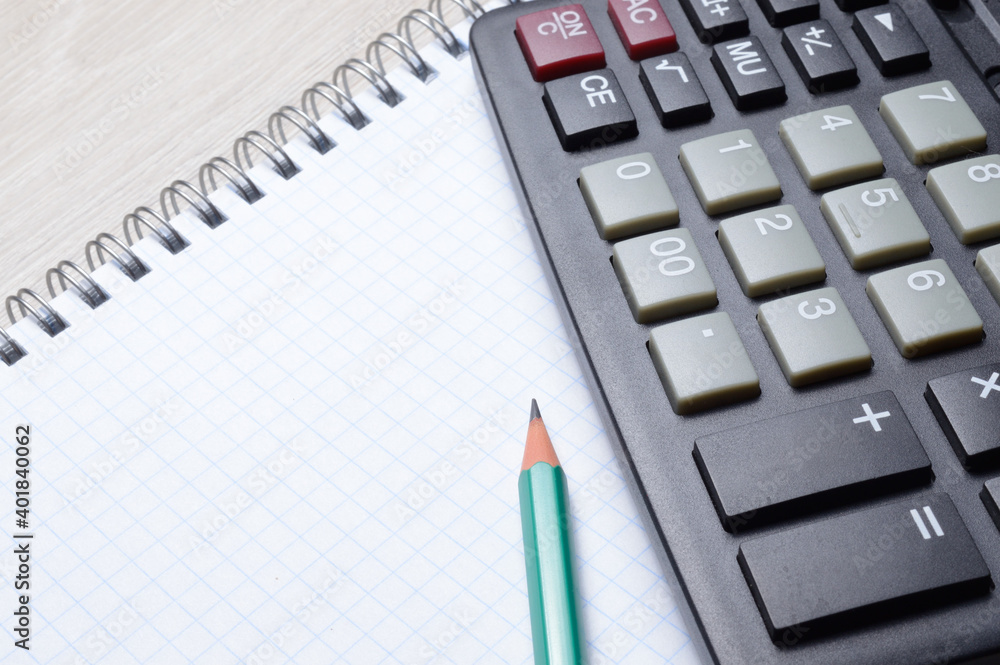 calculator, notebook and pencil lie together. close-up. calculator, notebook and pencil lie together. close-up.