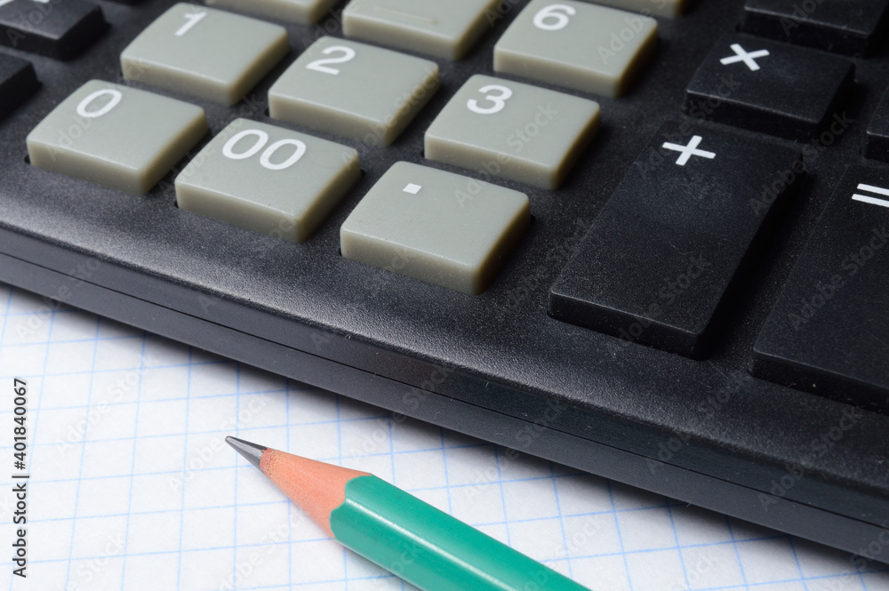calculator, notebook and pencil lie together. close-up. calculator, notebook and pencil lie together. close-up.