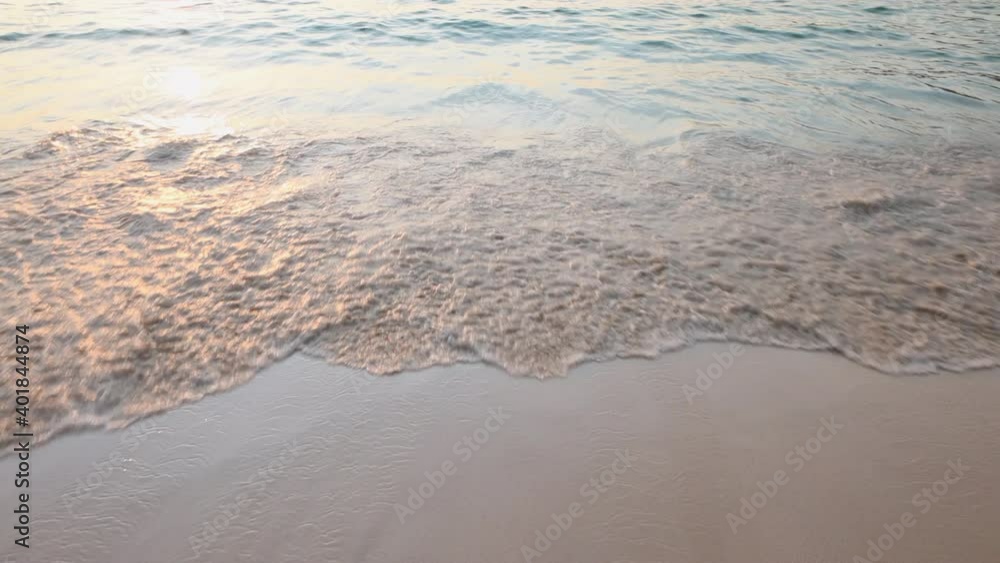 Tropical sandy beach with white foam waves in the evening. Phuket, Thailand Tropical sandy beach with white foam waves in the evening. Phuket, Thailand