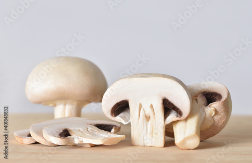 Sliced fresh champignons on a wooden cutting board