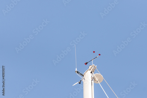 Top of the yacht's mast. Equipment on the top of the mast. Wind meter and weather indicator.