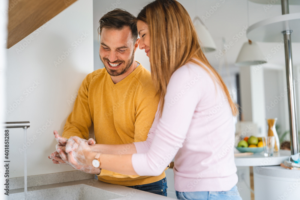 Happy couple, husban, wife are washing their hand. Protection against infection and virus Happy couple, husban, wife are washing their hand. Protection against infection and virus