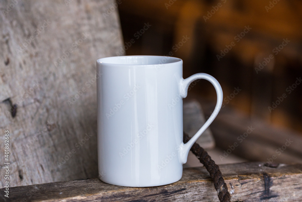 White porcelain coffee cup, mug on old wooden table White porcelain coffee cup, mug on old wooden table