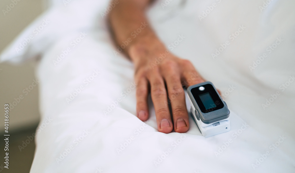 Close up photo of pulse oximeter on the patient finger in the hospital ward Close up photo of pulse oximeter on the patient finger in the hospital ward