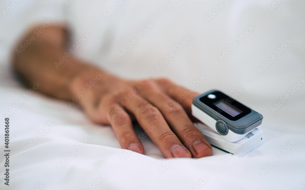 Close up photo of pulse oximeter on the patient finger in the hospital ward Close up photo of pulse oximeter on the patient finger in the hospital ward