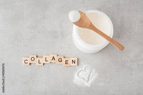 collagen powder in a spoon on a gray table, top view, heart, inscription collagen
