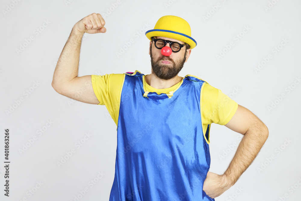 A clown in a bright blue and yellow suit shows off his muscles