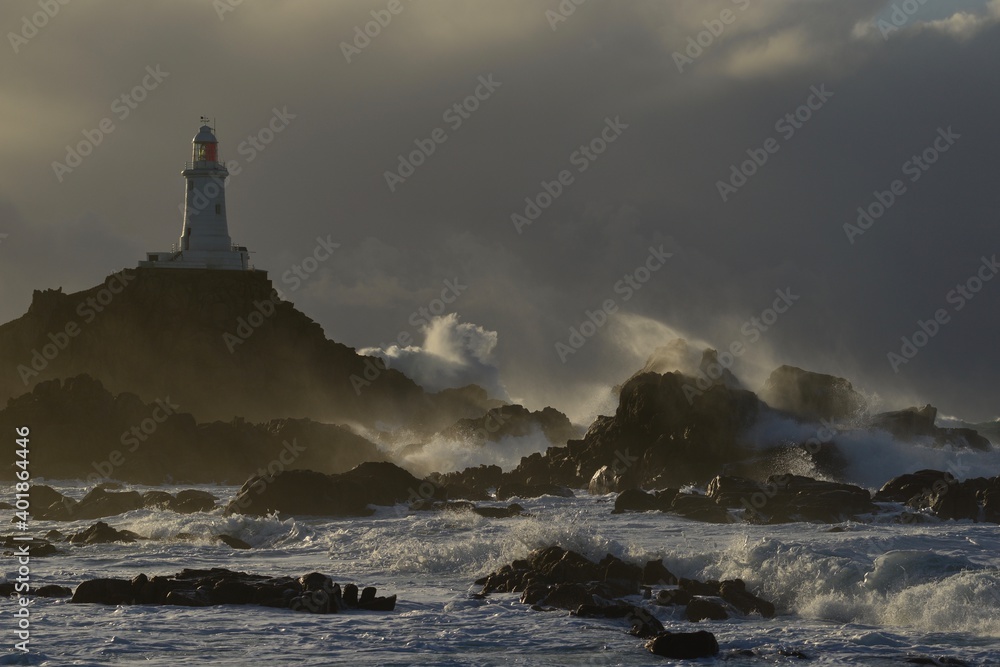 La Corbiere lighthouse, Jersey, U.K. Storm Bella in Winter whips up the Atlantic Ocean.
