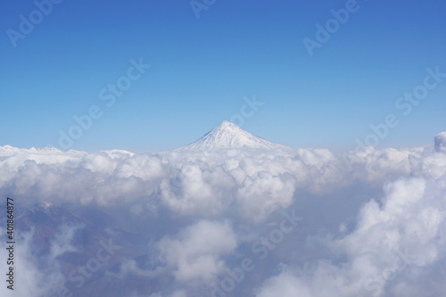 The magnificent Damavand peak surrounded by clouds captured in Iran photo