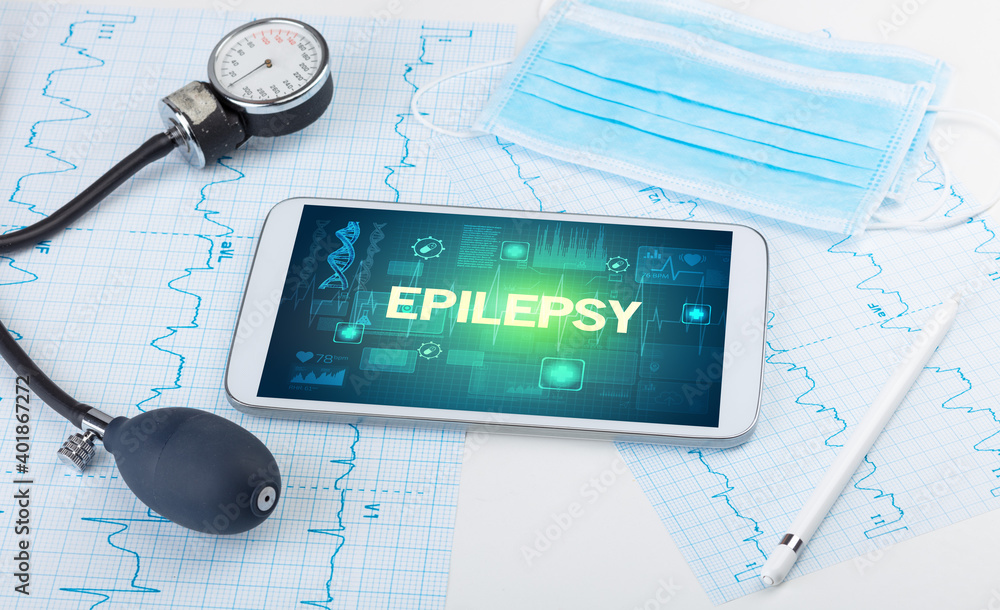 Tablet pc and medical stuff with EPILEPSY inscription, prevention concept Tablet pc and medical stuff with EPILEPSY inscription, prevention concept