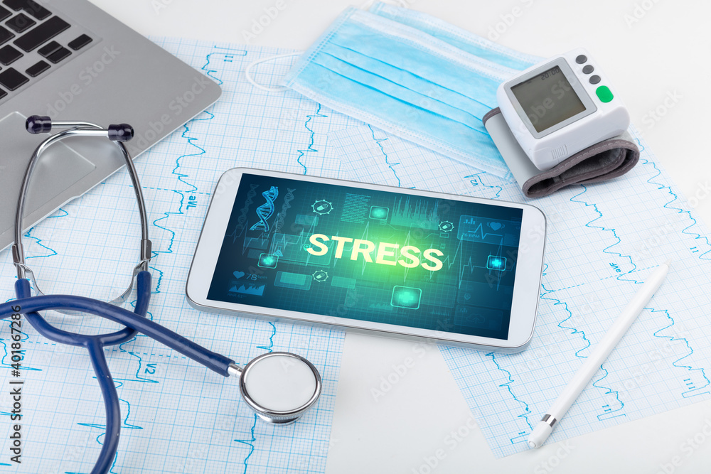Tablet pc and medical stuff with STRESS inscription, prevention concept Tablet pc and medical stuff with STRESS inscription, prevention concept