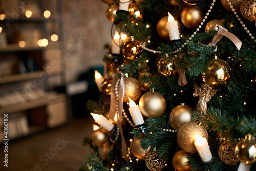 Close up of a decorated Christmas Tree with colourful decorations and garland lights  bokeh. Festive and New Year concept.