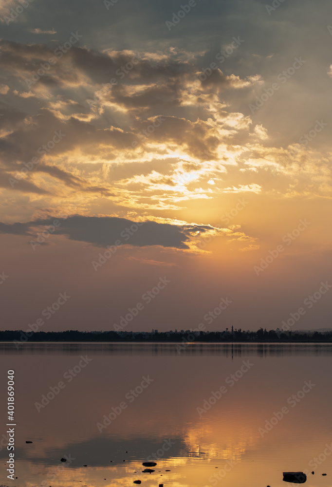 Sunset with clouds on the sky reflected on water Sunset with clouds on the sky reflected on water