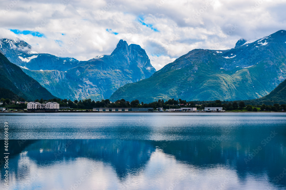 Beautiful landscape of mountains reflected in Romsdal Fjord or Romsdalsfjord in cloudy weather. More og Romsdal county. Norway.