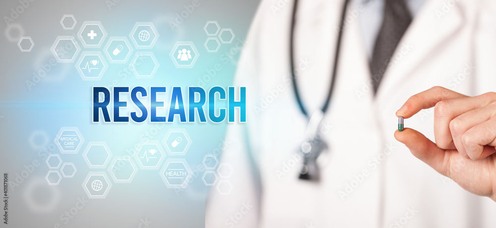 Close-up of a doctor giving you a pill with RESEARCH inscription, medical concept Close-up of a doctor giving you a pill with RESEARCH inscription, medical concept