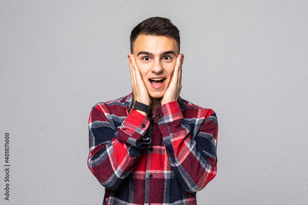 Omg no way. Impressed, shocked handsome questioned guy in blue shirt over t-shirt, drop jaw astonished, gasping from amazement and wonder, popping eyes camera on white background