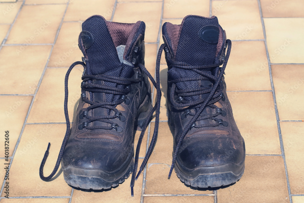 a pair of used dusty and dirty leather brown hiking boots a pair of used dusty and dirty leather brown hiking boots