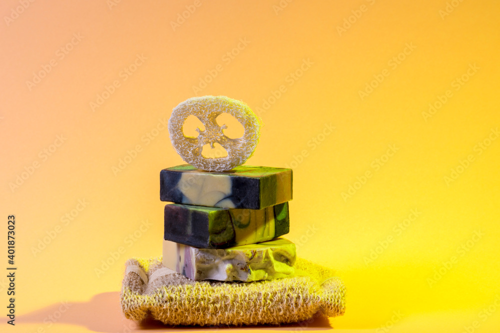 Handmade soap and loofah sponge on a yellow color background. Zero waste, eco friendly cosmetics concept. Eco lifestyle theme. Handmade soap and loofah sponge on a yellow color background. Zero waste, eco friendly cosmetics concept. Eco lifestyle theme.