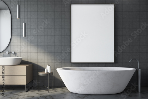 Modern gray bathroom with blank poster on wall.