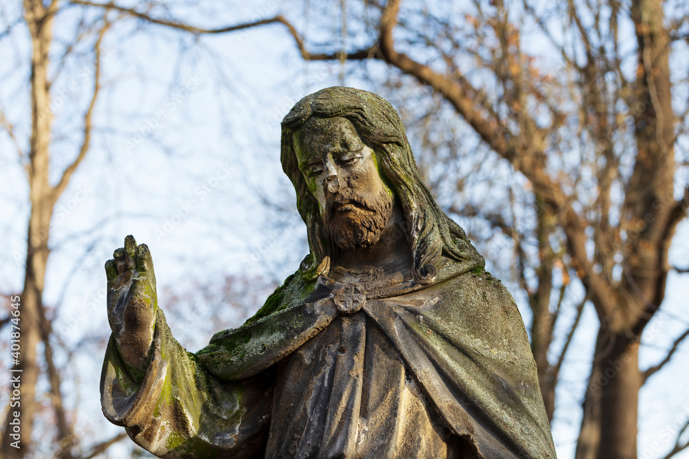 Historic Jesus on the winter mystery old Prague Cemetery, Czech Republic