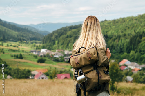 Girl enjoy scenics view on valley. Beautiful nature landscape in mountains. Hiking journey on tourist trail. Outdoor adventure. Travel and exploration. Healthy lifestyle, leisure activities