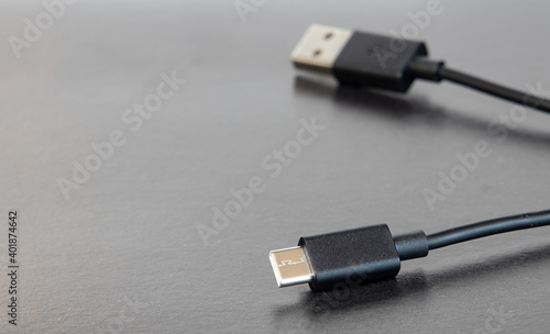 black USB type-c charger gadget object on gray background texture office table surface empty copy space for your text here